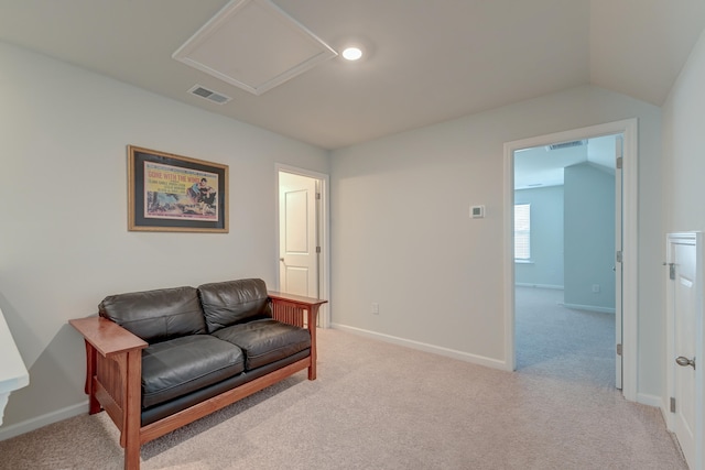 living area with light colored carpet and vaulted ceiling