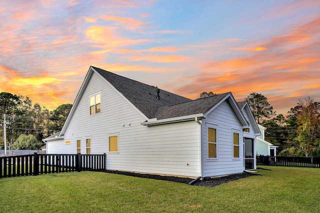 back house at dusk with a yard