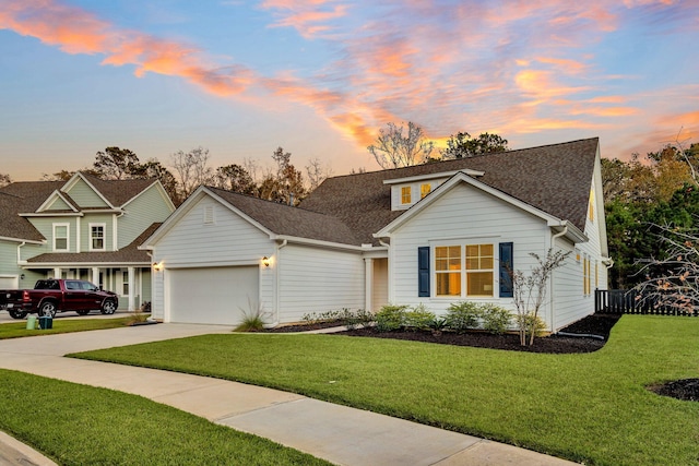 view of front facade featuring a yard, a garage, and central air condition unit