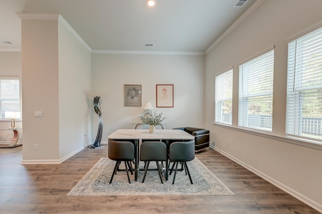 dining area featuring a wealth of natural light, hardwood / wood-style floors, and ornamental molding