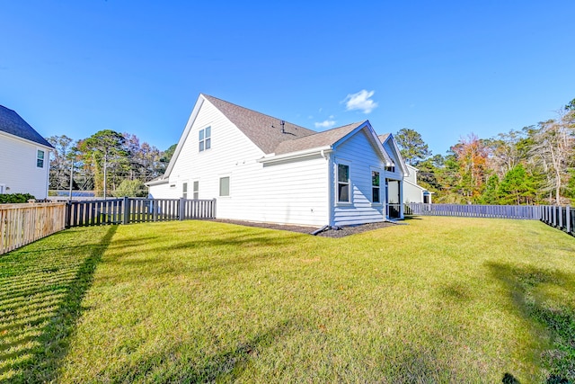 rear view of house with a lawn