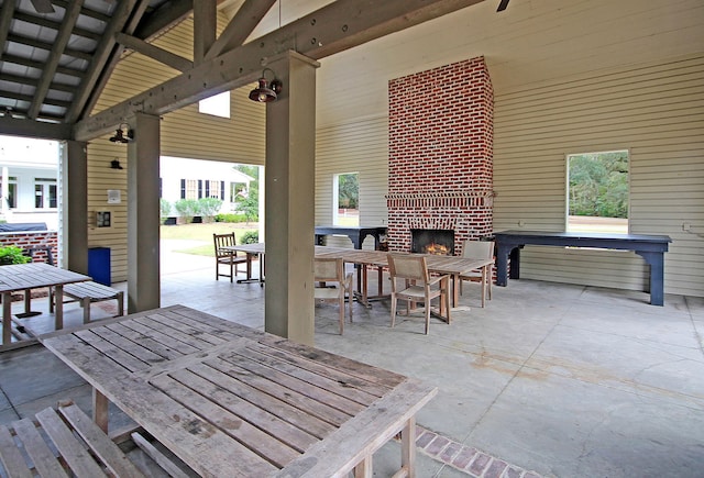 view of patio / terrace featuring a gazebo and an outdoor brick fireplace