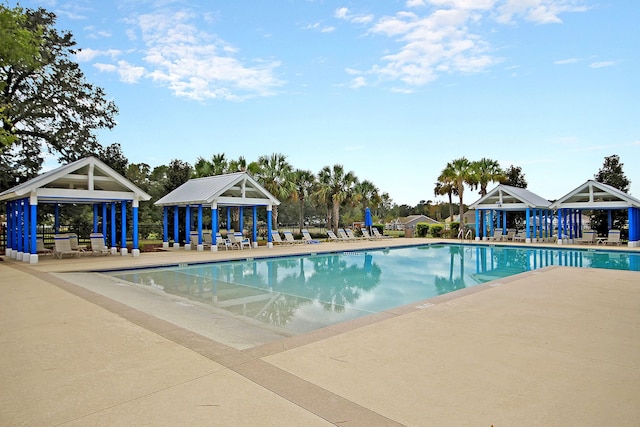 view of swimming pool featuring a patio area and an outdoor structure