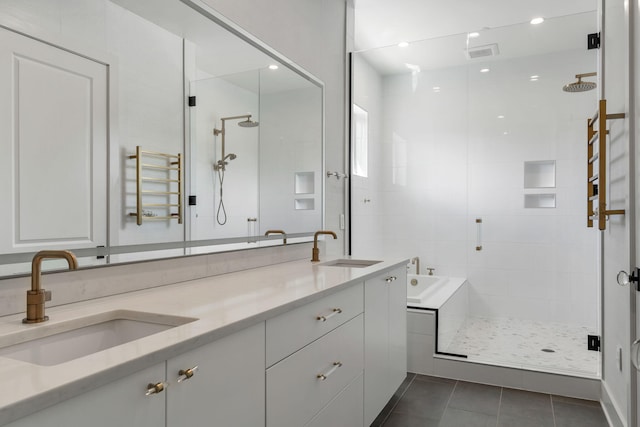 bathroom with tile patterned flooring, vanity, and plus walk in shower