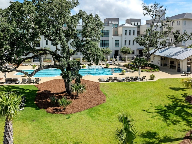 view of pool with a lawn