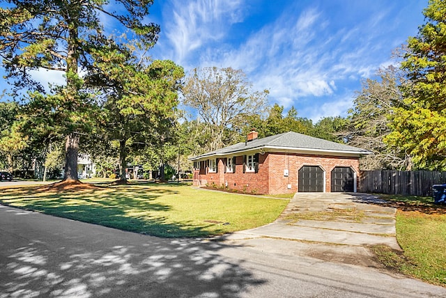 view of front of property featuring a garage and a front lawn