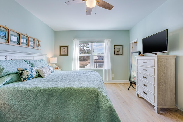 bedroom with light hardwood / wood-style floors and ceiling fan