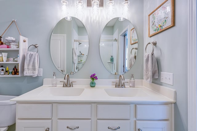 bathroom with vanity, walk in shower, and toilet