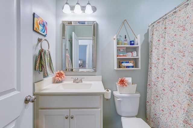 bathroom with vanity, walk in shower, and toilet