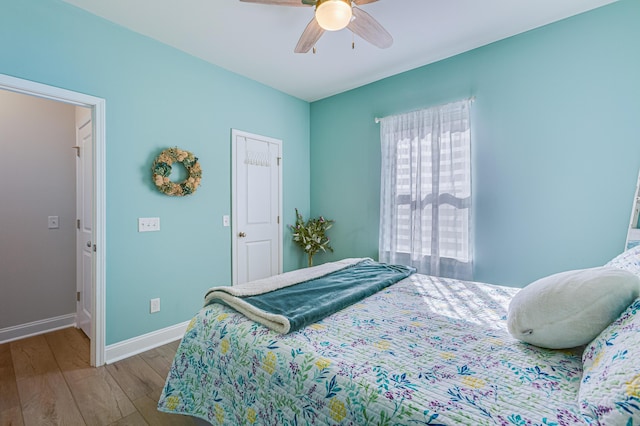 bedroom with wood-type flooring and ceiling fan