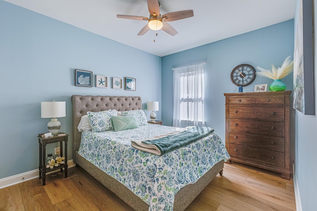 bedroom with ceiling fan and light hardwood / wood-style floors