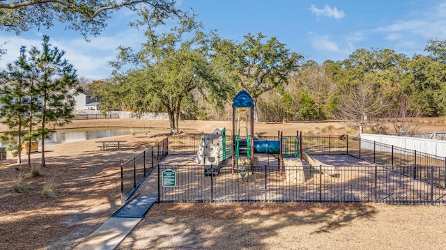 view of jungle gym with a water view