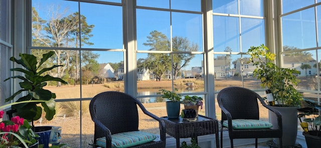 sunroom / solarium with a water view