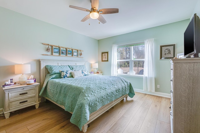 bedroom with ceiling fan and light hardwood / wood-style flooring