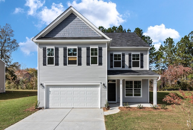 view of property featuring a front yard and a garage