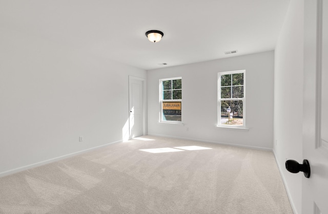 spare room with light colored carpet