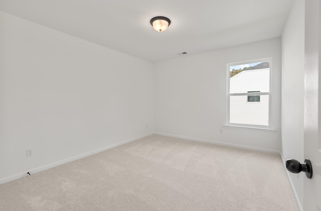 spare room with light carpet