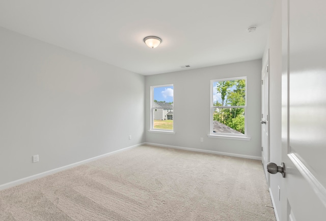 empty room featuring light colored carpet