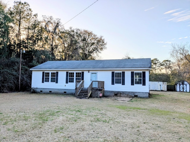 view of front of property featuring an outbuilding, a shed, and crawl space