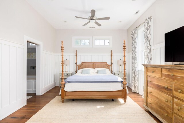 bedroom with ensuite bathroom, ceiling fan, and dark hardwood / wood-style floors