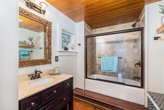 bathroom with bath / shower combo with glass door, wooden ceiling, and vanity