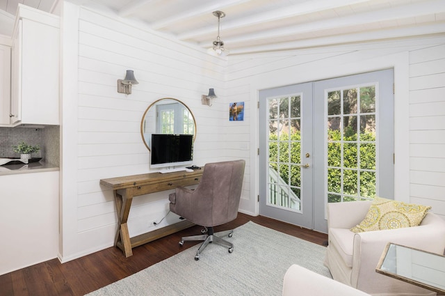 home office with lofted ceiling with beams, wood walls, dark hardwood / wood-style flooring, and french doors