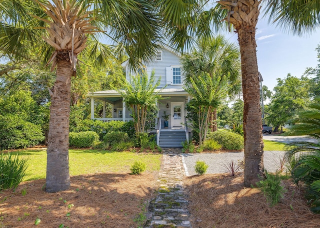 view of front of property featuring covered porch and a front lawn