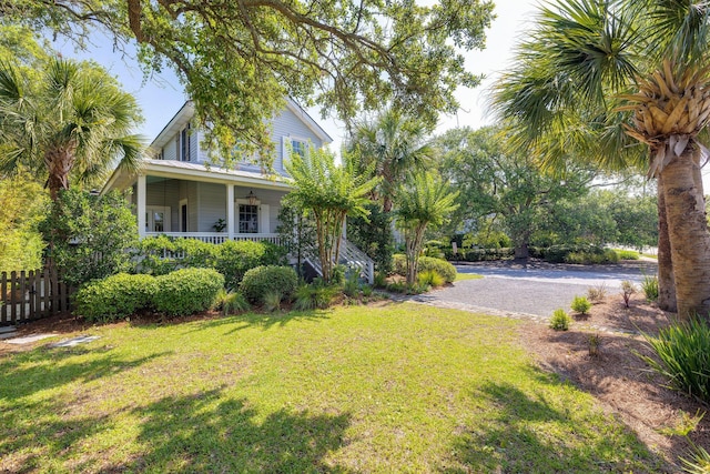 view of yard featuring covered porch