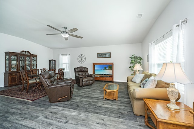 living room featuring vaulted ceiling, a ceiling fan, wood finished floors, and visible vents