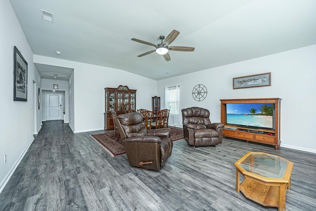 living area featuring baseboards, ceiling fan, wood finished floors, and visible vents