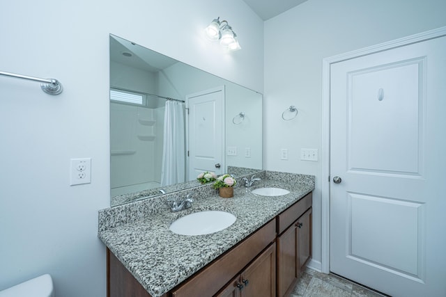full bath featuring a sink, toilet, double vanity, and a shower with shower curtain