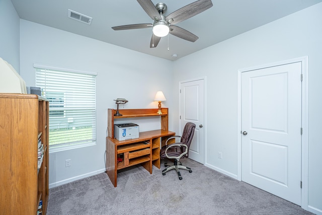 carpeted office with visible vents, baseboards, and ceiling fan