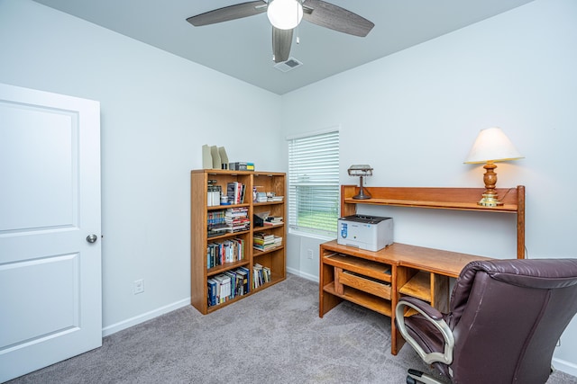 carpeted home office with baseboards, a ceiling fan, and visible vents