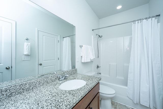 bathroom with toilet, shower / bath combo, and vanity