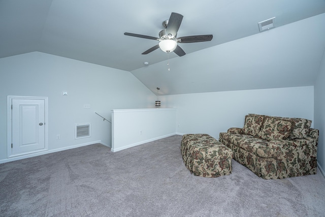 living area featuring an upstairs landing, vaulted ceiling, and visible vents