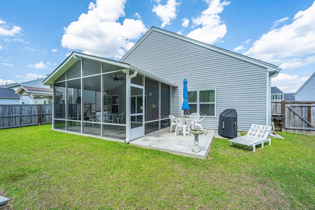 back of house with a ceiling fan, a lawn, a sunroom, a fenced backyard, and a patio