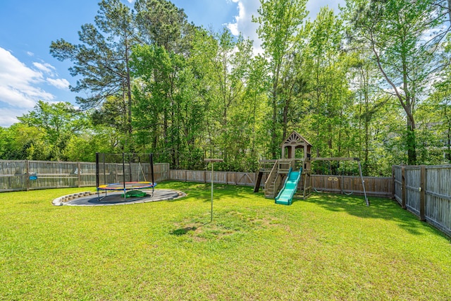 view of yard featuring a fenced backyard, a trampoline, and a playground