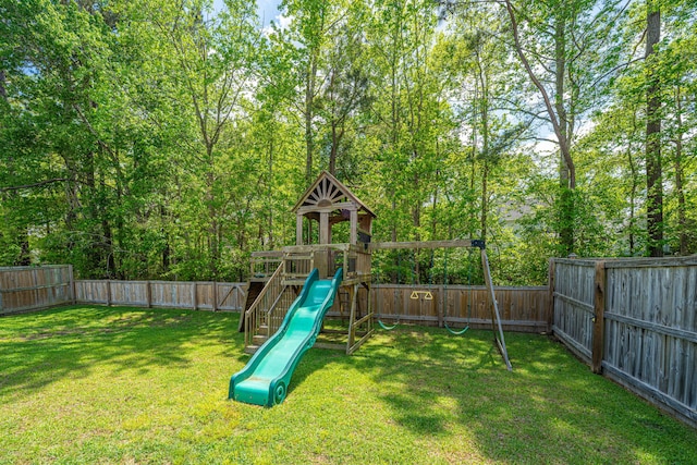 view of jungle gym featuring a lawn and a fenced backyard