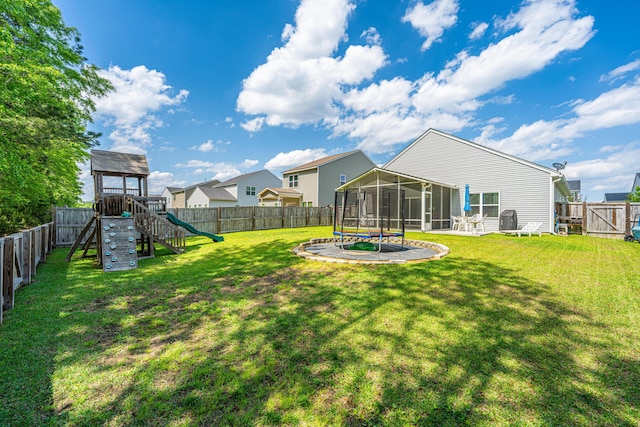 view of yard with a playground, a sunroom, and a fenced backyard