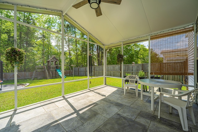 sunroom featuring a ceiling fan and outdoor dining area