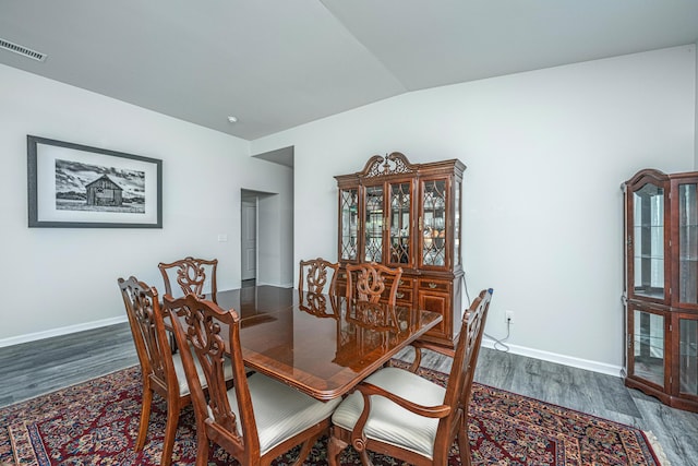 dining area featuring baseboards, wood finished floors, and visible vents