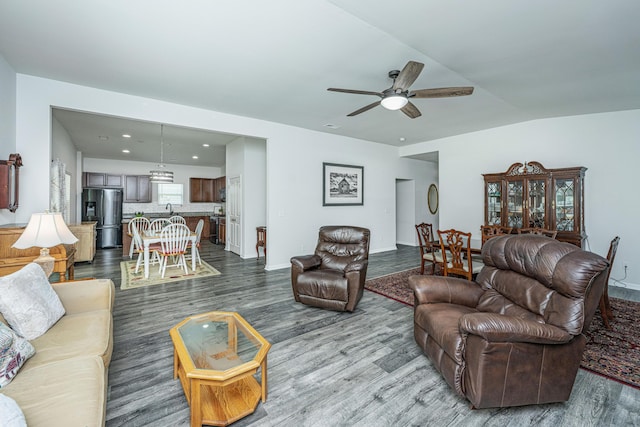 living area with a ceiling fan, recessed lighting, and wood finished floors