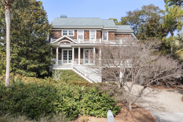 view of front of property with french doors and a balcony