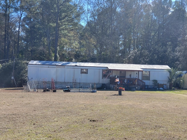 back of house with a lawn