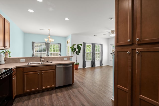 kitchen with stainless steel dishwasher, a sink, dark wood-type flooring, and a healthy amount of sunlight