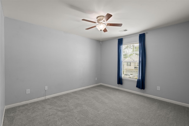 unfurnished room with baseboards, a ceiling fan, visible vents, and carpet flooring