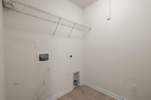 clothes washing area featuring hookup for an electric dryer, light tile patterned flooring, baseboards, laundry area, and washer hookup