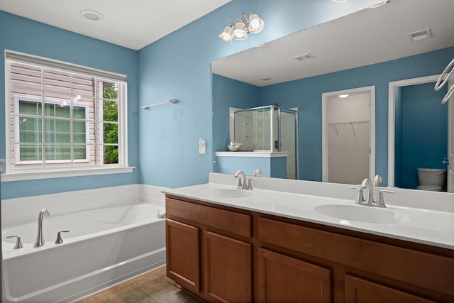 full bathroom featuring a bath, a shower stall, visible vents, and a sink