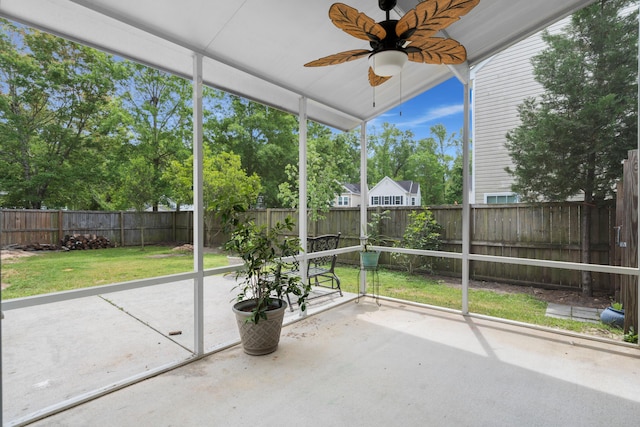 unfurnished sunroom featuring ceiling fan