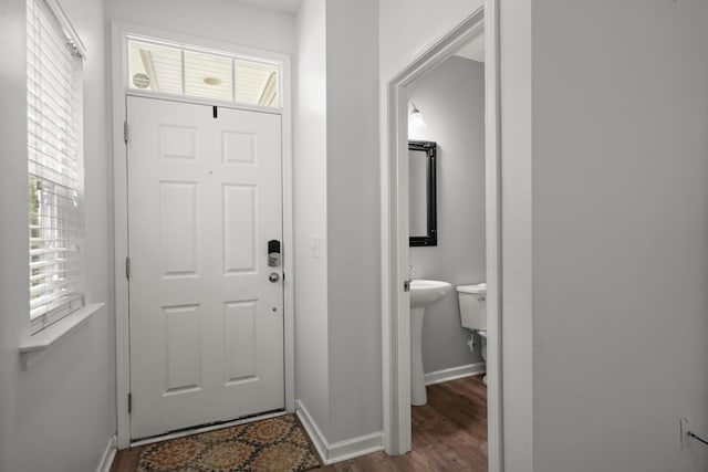 entryway with wood finished floors and baseboards